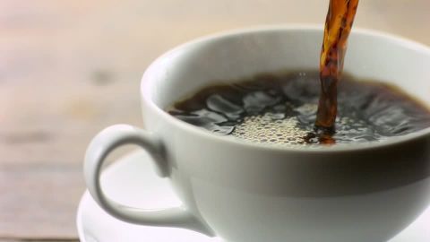 Coffee being poured into coffee cup