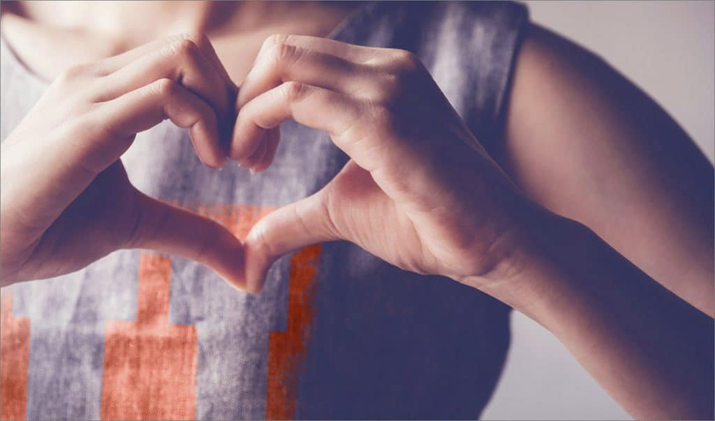 Person making heart sign with hands