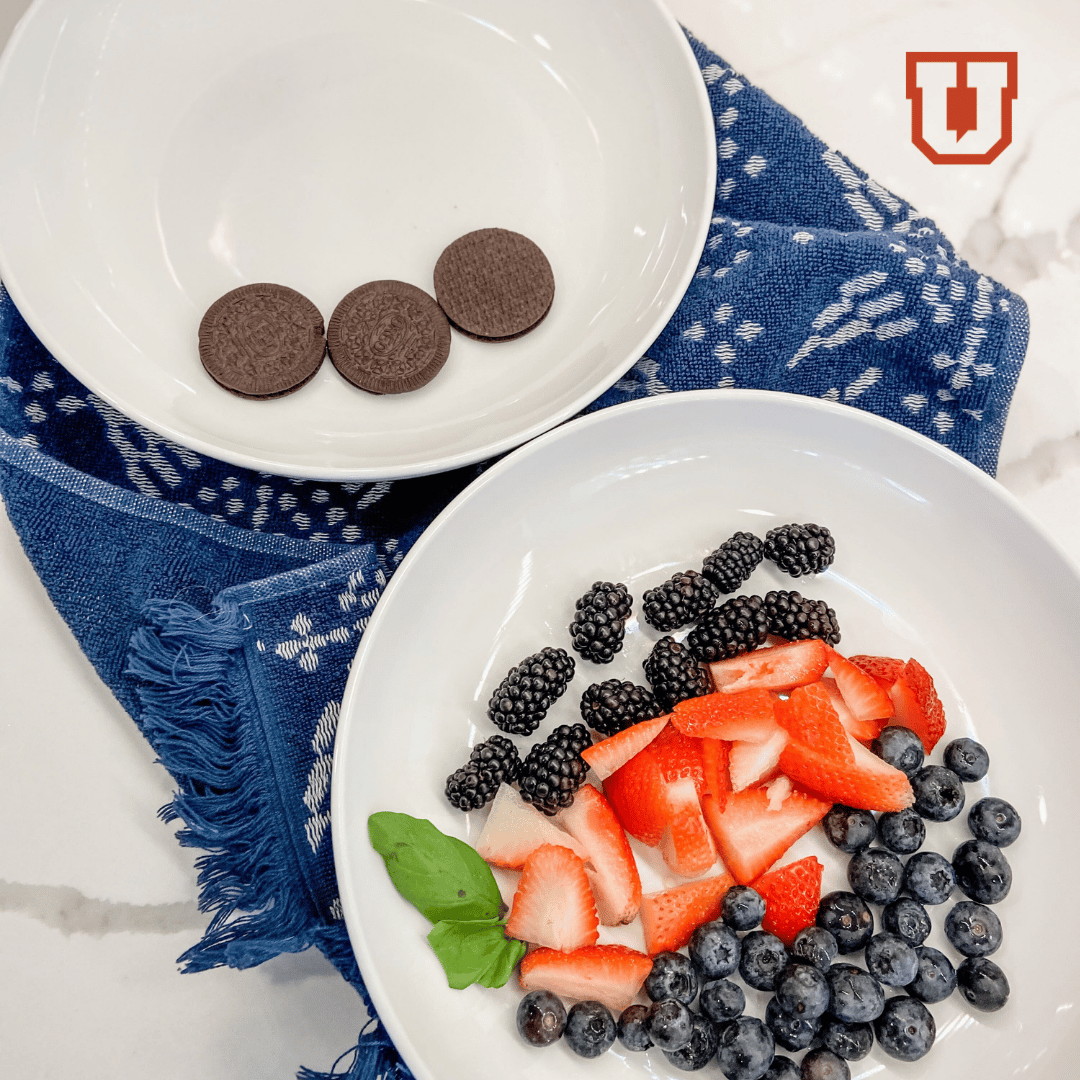 Two plates one with oreos and one with fruit