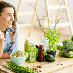 Female smiling with green produce in front of her