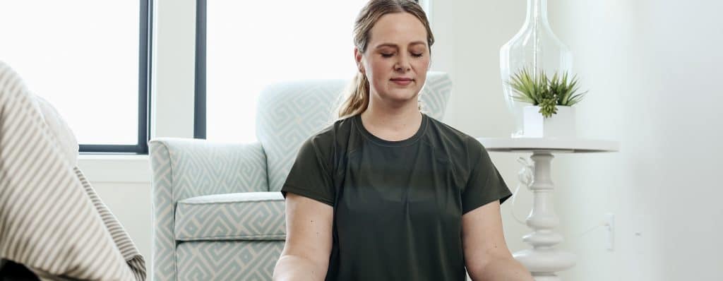 Peaceful Woman Meditating at Home