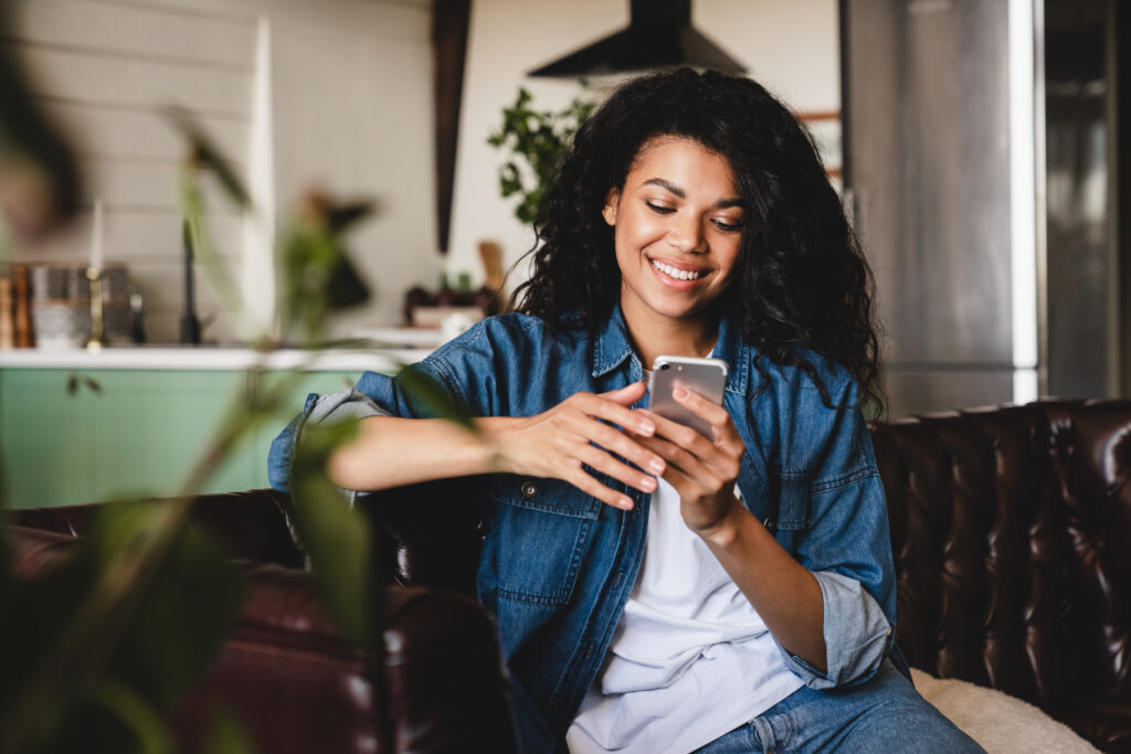 woman on her phone on a couch